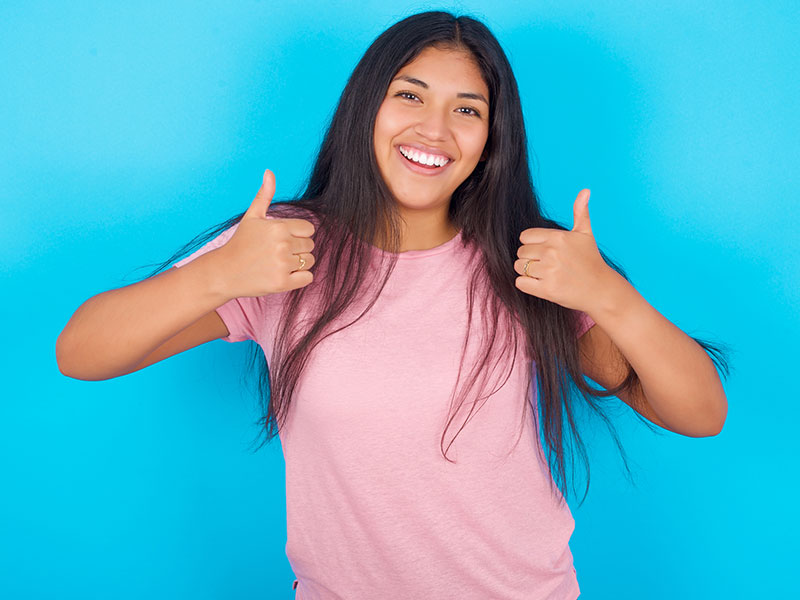 Model Giving Thumbs Up With Positive Body Language