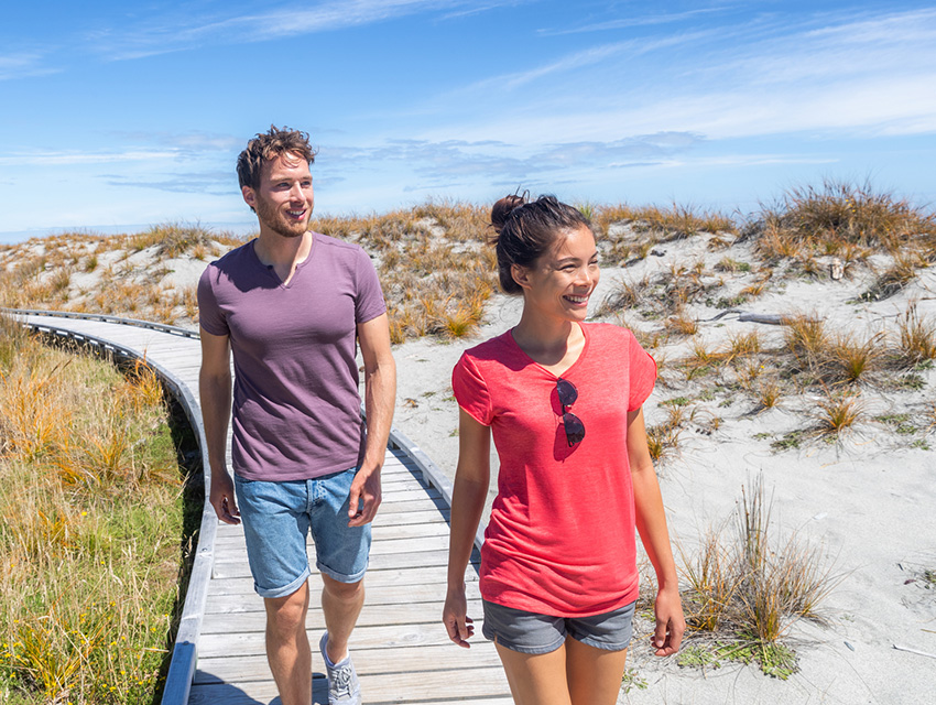 Smiling People Walking Along Boardwalk at Ship Creek